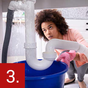 woman looking under sink