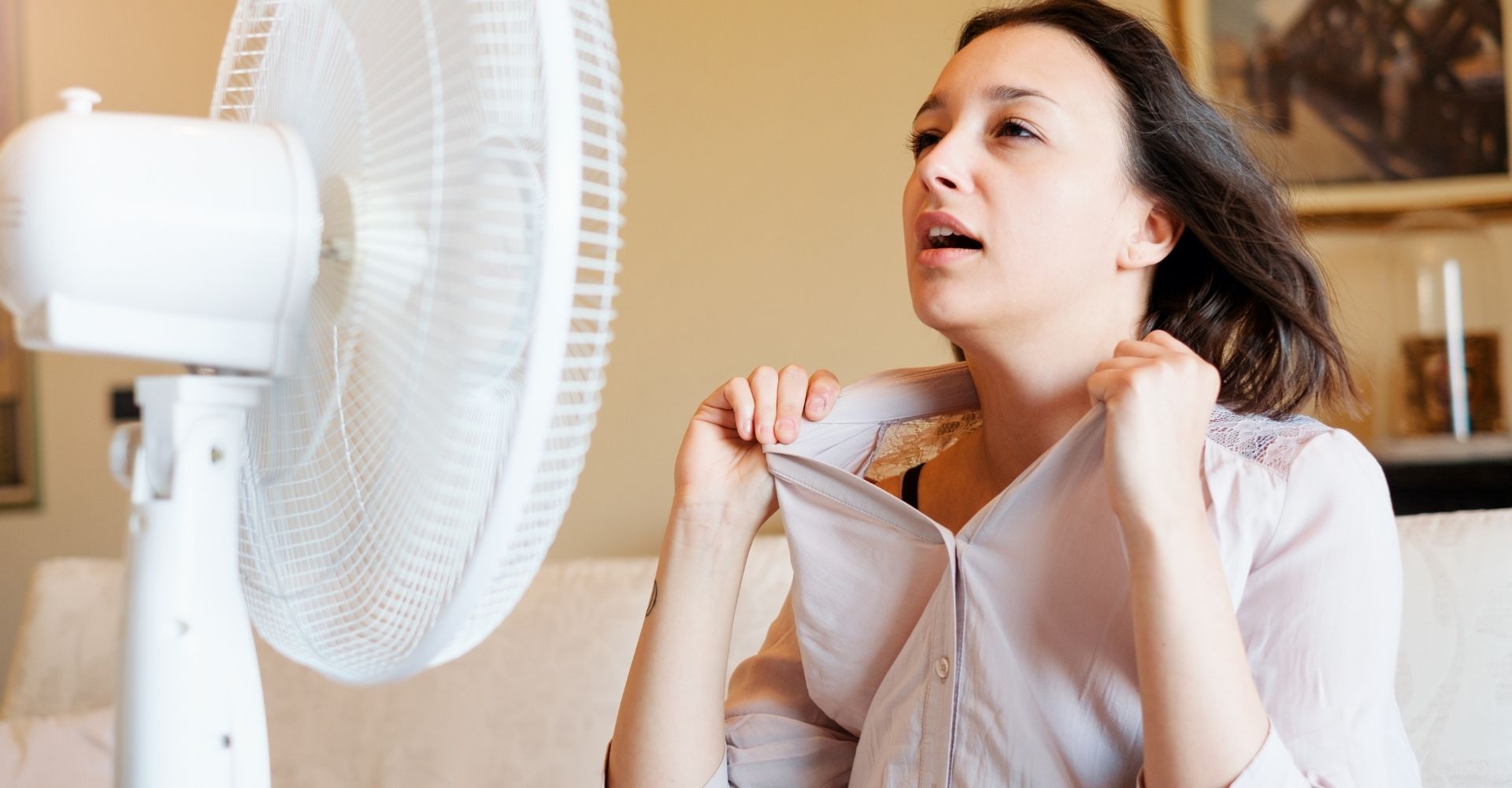 woman shaking her collar because she is hot