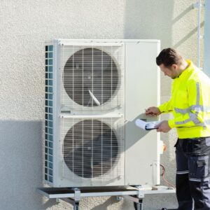 man inspecting air conditioning