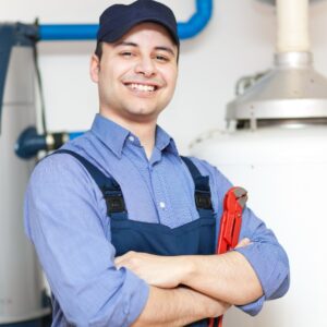 A smiling repair technician holding a tool