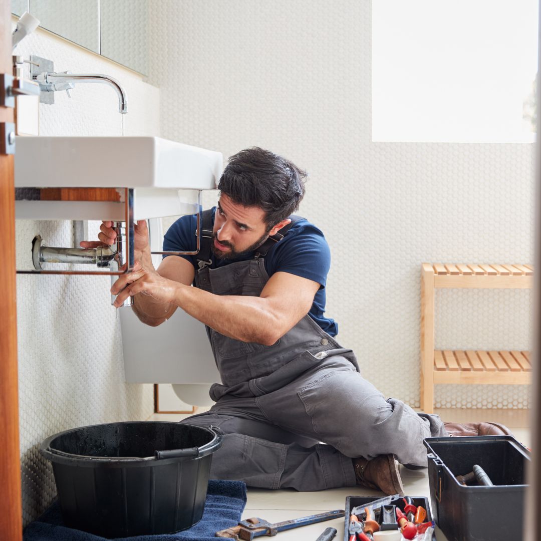 Plumber working on sink