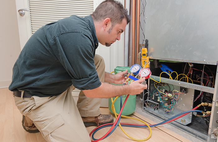 a professional testing a home ac unit