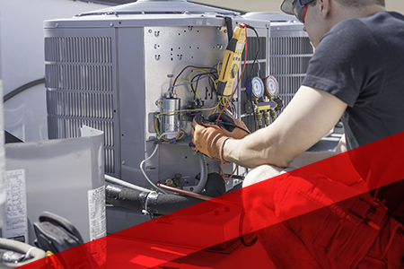 a person in safety gear testing an ac unit