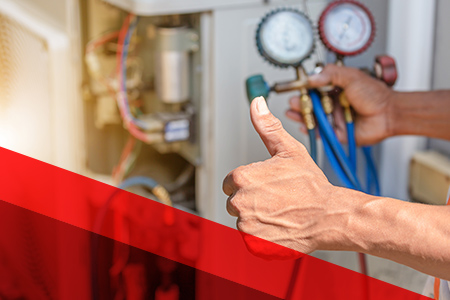 a person giving a thumbs up in front of an ac repair