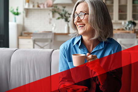 person smiling holding mug