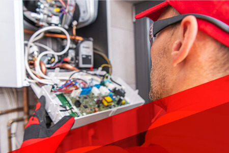 technician examining inside of furnace