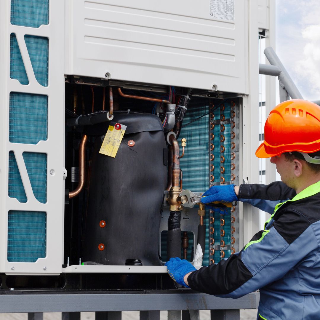 technician working on a commercial HVAC system