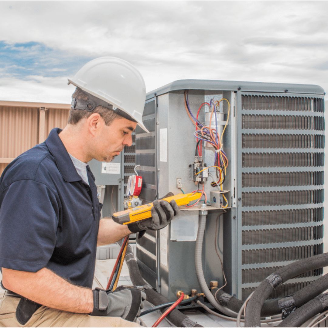 worker calibrating an ac unit
