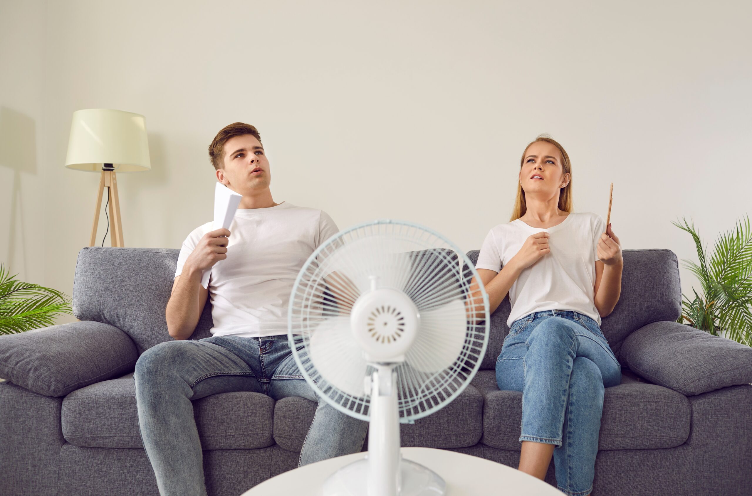 couple fanning themselves off because ac is broken