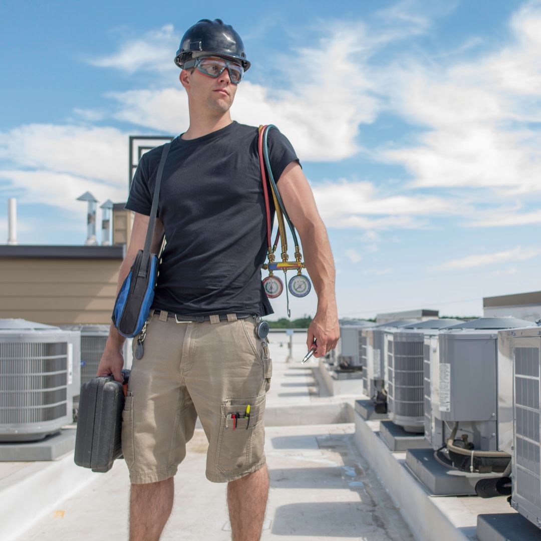 technician standing on a roof with equipment