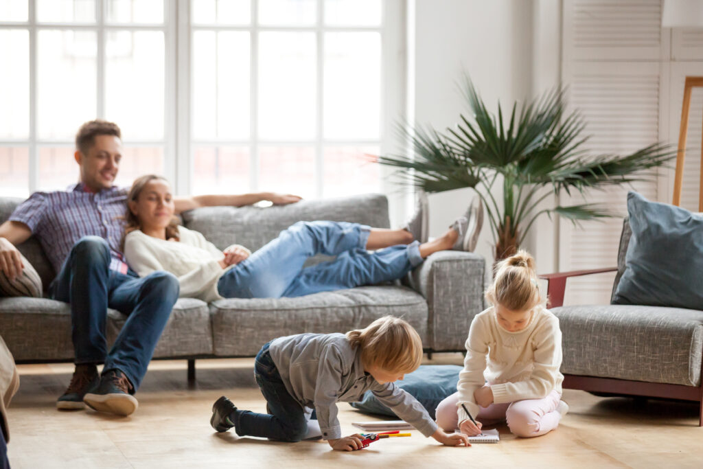 family sitting in living room enjoying ac