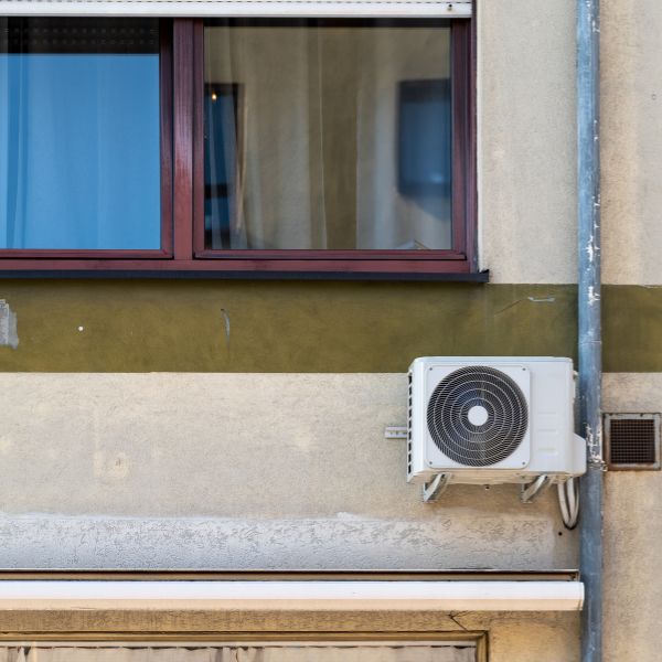 a heat pump on the outside of an apartment