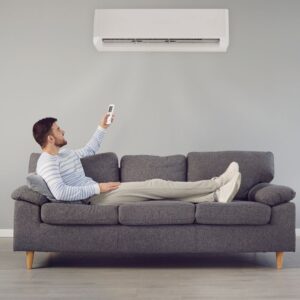 a man turning on an ac unit