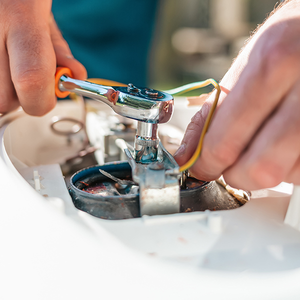 a technician working on a water heater
