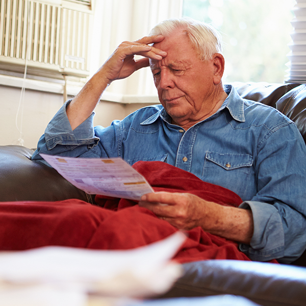 a man warming himself off with a blanket while looking at their bill