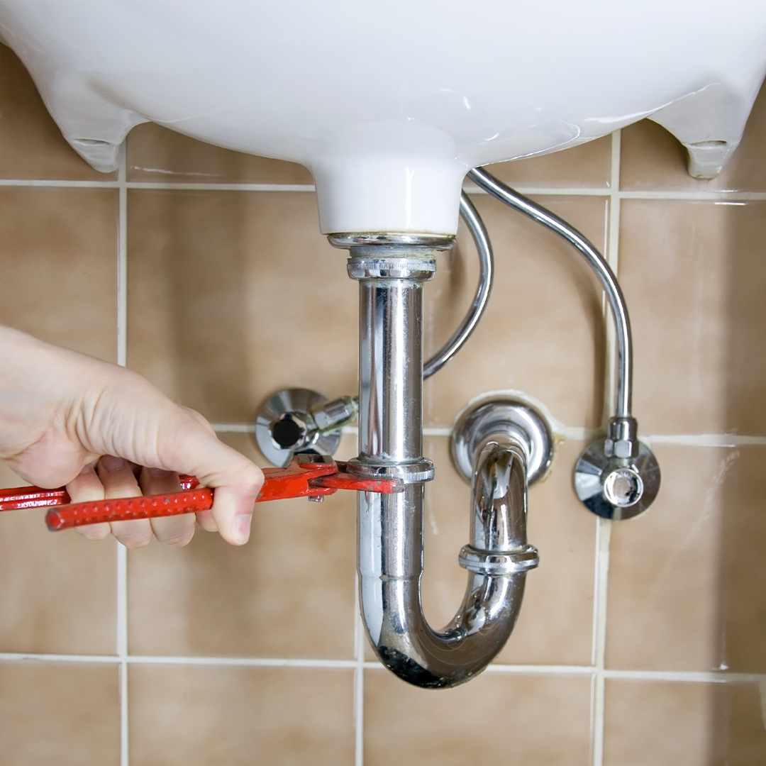 a plumber fixing a pipe