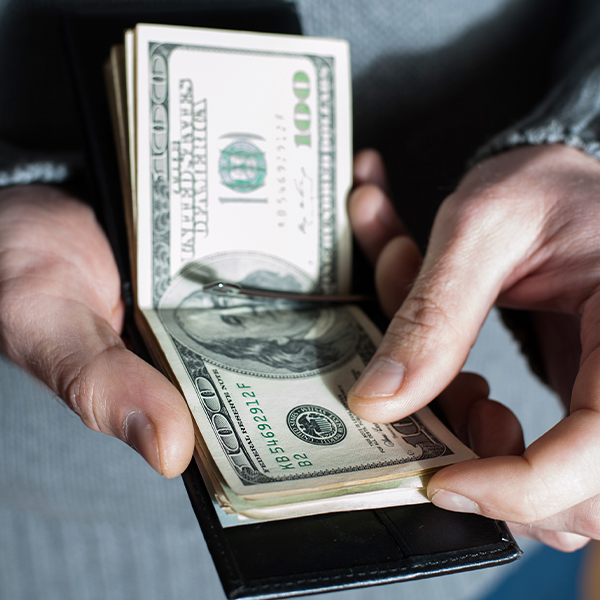 a man counting money in his wallet