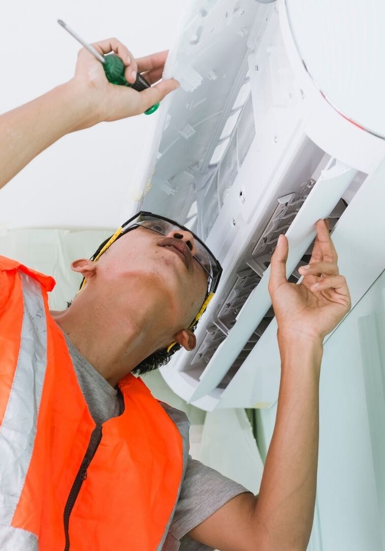 technician inspecting an AC unit