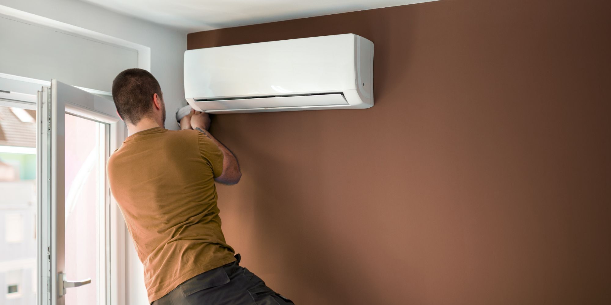 man installing ductless mini split